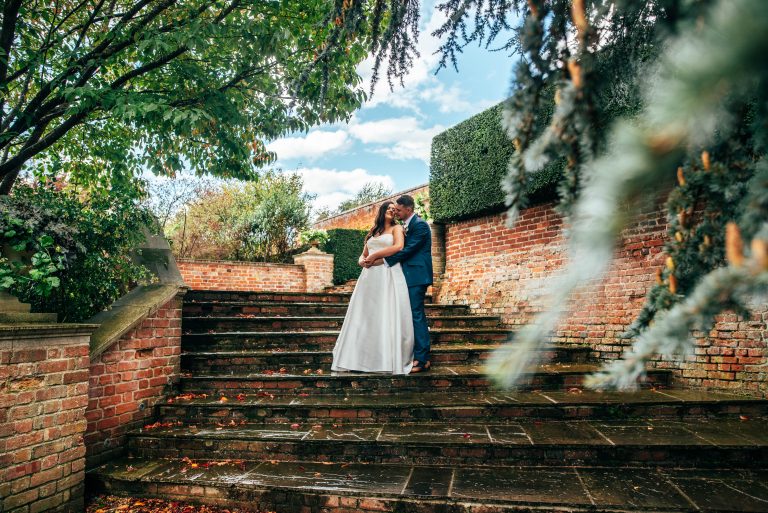 Bride and groom on steps at Braxted Park