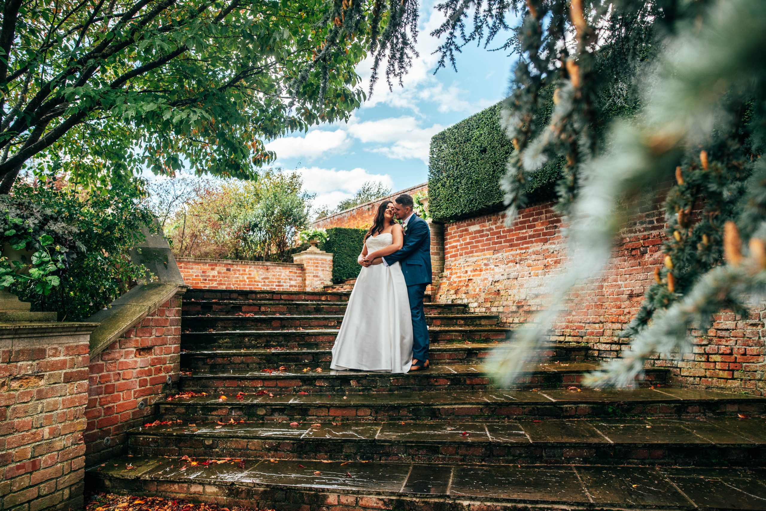 Bride and groom on steps at Braxted Park