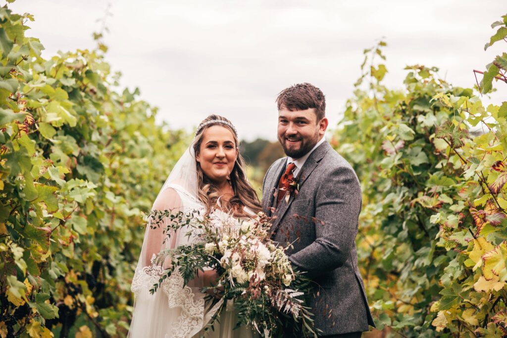 AUTUMN BRIDE AND GROOM IN VINEYARD AT TUFFON HALL WEDDINGS BEST ESSEX DOCUMENTARY WEDDING PHOTOGRAPHER