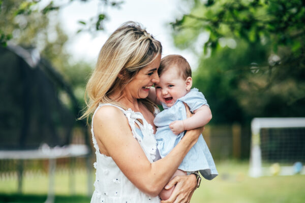 Mum and her baby girl laugh in garden Essex lifestyle family baby childhood photographer