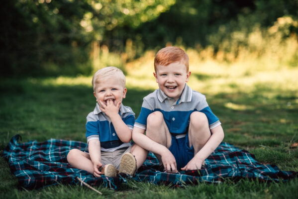 two little boys sit on blanket and laugh Essex family lifestyle baby childhood photographer