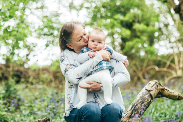 nanna kisses baby girl in bluebell wood Essex family lifestyle baby childhood photographer