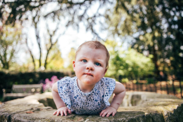 Little girl with blue eyes stares into camera Essex family lifestyle baby childhood photographer