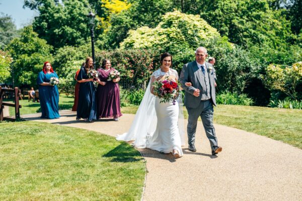 Jewelled tones, lawn games & axe throwing for this White Hart, Great Yeldham wedding. Best Essex Suffolk documentary wedding photographer