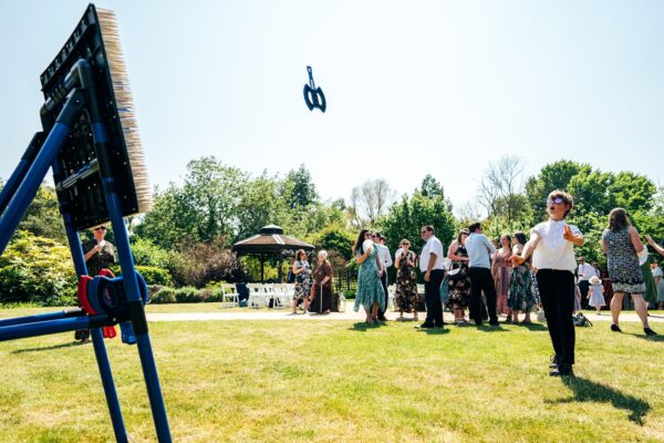 Jewelled tones, lawn games & axe throwing for this White Hart, Great Yeldham wedding. Best Essex Suffolk documentary wedding photographer