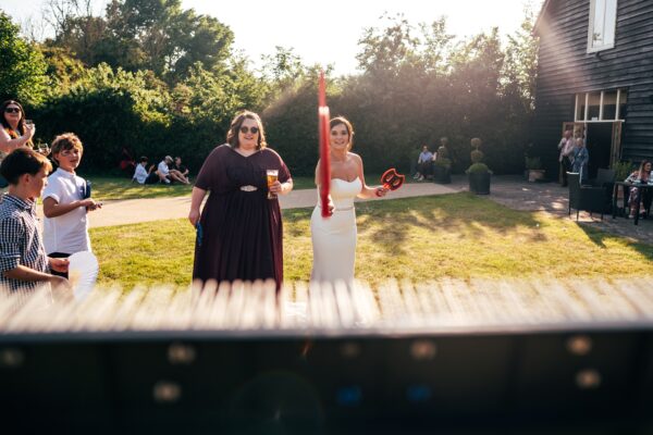 Jewelled tones, lawn games & axe throwing for this White Hart, Great Yeldham wedding. Best Essex Suffolk documentary wedding photographer