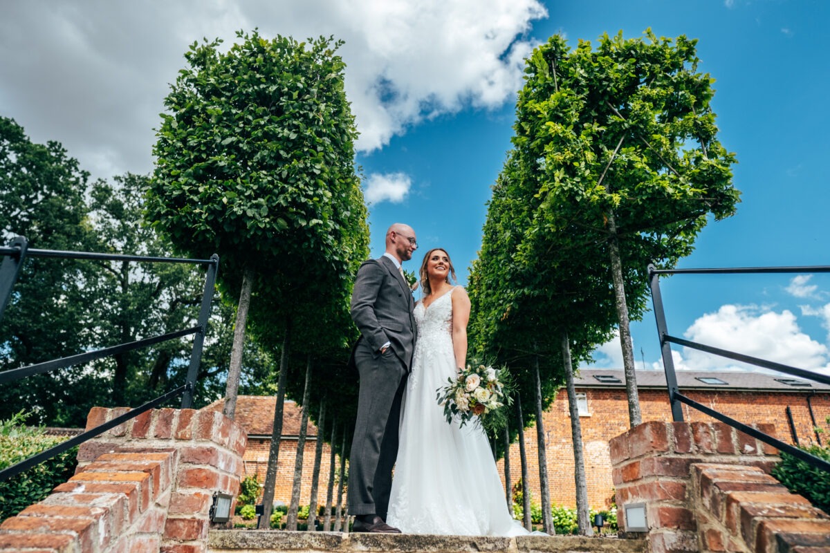 Bride & Groom in gardens at Hatfield Place. Best Essex Documentary Wedding Photographer