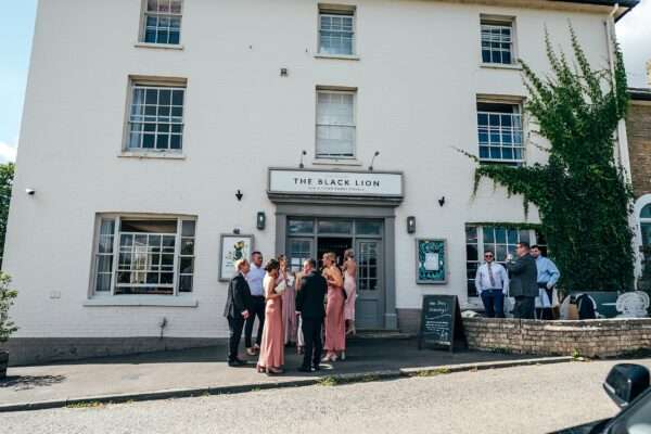 Impossibly chic, black tie wedding at The Hare's Field, with Bridesmaids in mismatched pinks and dried flowers. Best Essex Documentary Wedding Photographer