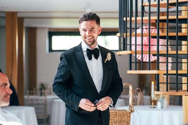 Impossibly chic, black tie wedding at The Hare's Field, with Bridesmaids in mismatched pinks and dried flowers. Best Essex Documentary Wedding Photographer