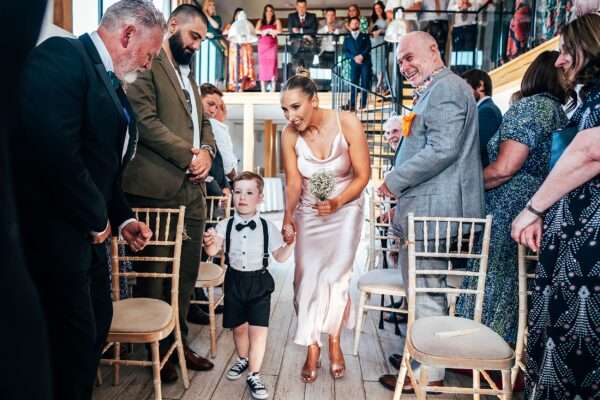 Impossibly chic, black tie wedding at The Hare's Field, with Bridesmaids in mismatched pinks and dried flowers. Best Essex Documentary Wedding Photographer