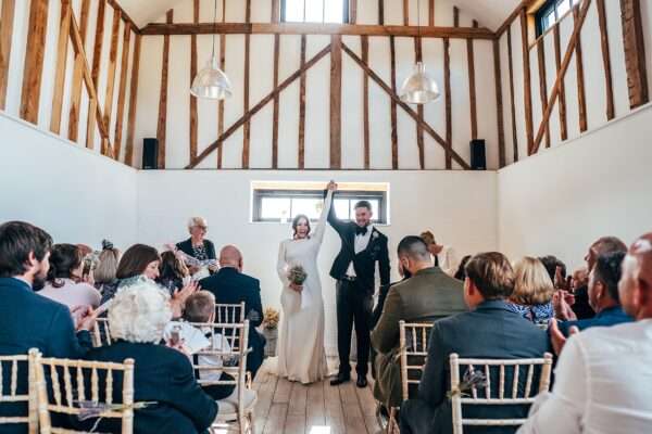 Impossibly chic, black tie wedding at The Hare's Field, with Bridesmaids in mismatched pinks and dried flowers. Best Essex Documentary Wedding Photographer