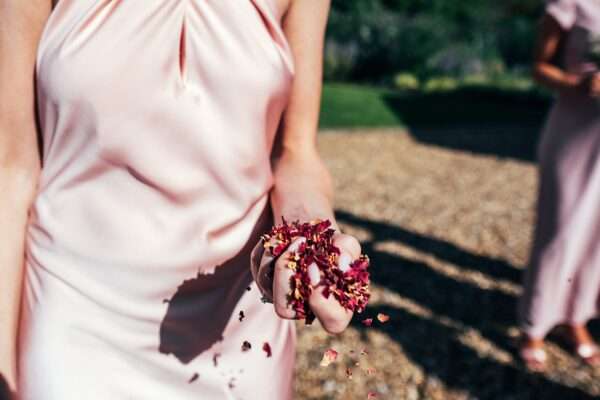 Impossibly chic, black tie wedding at The Hare's Field, with Bridesmaids in mismatched pinks and dried flowers. Best Essex Documentary Wedding Photographer