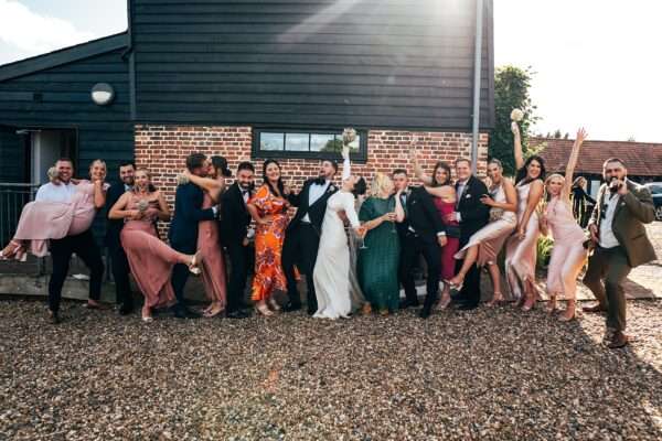 Impossibly chic, black tie wedding at The Hare's Field, with Bridesmaids in mismatched pinks and dried flowers. Best Essex Documentary Wedding Photographer