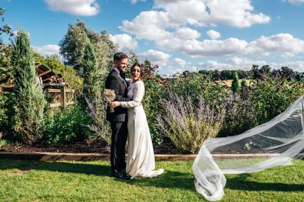 Impossibly chic, black tie wedding at The Hare's Field, with Bridesmaids in mismatched pinks and dried flowers. Best Essex Documentary Wedding Photographer