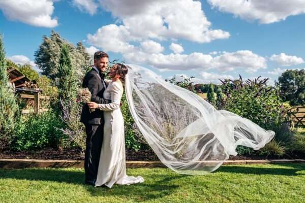 Impossibly chic, black tie wedding at The Hare's Field, with Bridesmaids in mismatched pinks and dried flowers. Best Essex Documentary Wedding Photographer