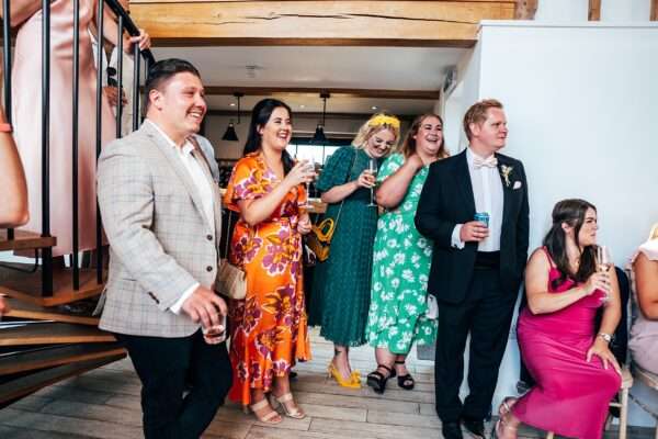 Impossibly chic, black tie wedding at The Hare's Field, with Bridesmaids in mismatched pinks and dried flowers. Best Essex Documentary Wedding Photographer