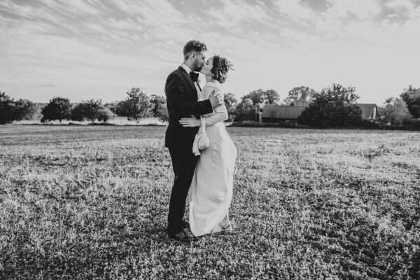 Impossibly chic, black tie wedding at The Hare's Field, with Bridesmaids in mismatched pinks and dried flowers. Best Essex Documentary Wedding Photographer