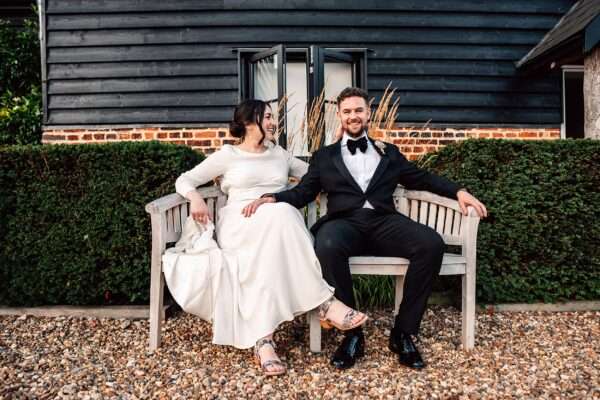 Impossibly chic, black tie wedding at The Hare's Field, with Bridesmaids in mismatched pinks and dried flowers. Best Essex Documentary Wedding Photographer