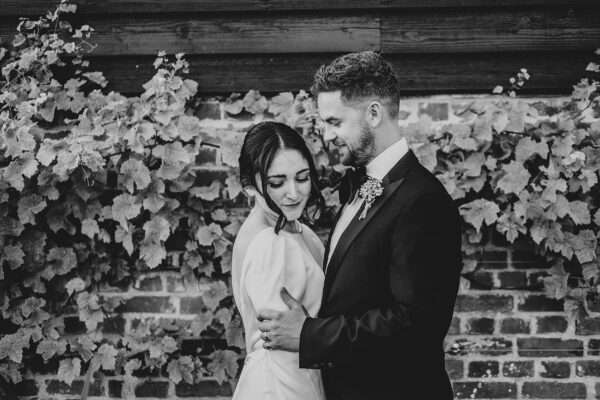 Impossibly chic, black tie wedding at The Hare's Field, with Bridesmaids in mismatched pinks and dried flowers. Best Essex Documentary Wedding Photographer