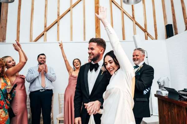 Impossibly chic, black tie wedding at The Hare's Field, with Bridesmaids in mismatched pinks and dried flowers. Best Essex Documentary Wedding Photographer