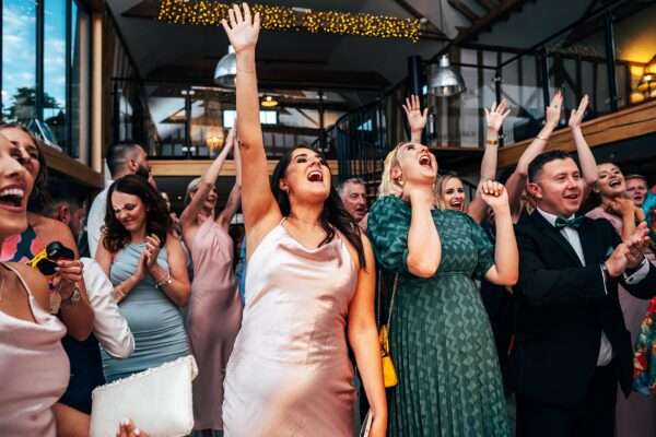 Impossibly chic, black tie wedding at The Hare's Field, with Bridesmaids in mismatched pinks and dried flowers. Best Essex Documentary Wedding Photographer