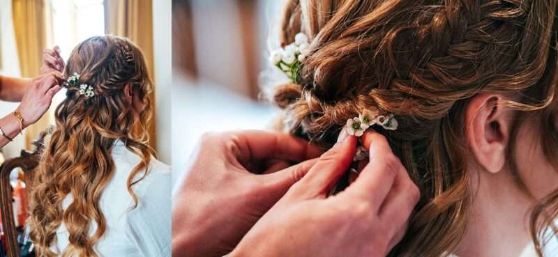 tiny white flowers in brides red plaited hair for Captains Wood Barn wedding