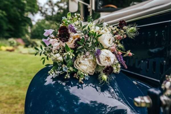 Wild flower bridal bouquet on vintage bus at Captains Wood Barn