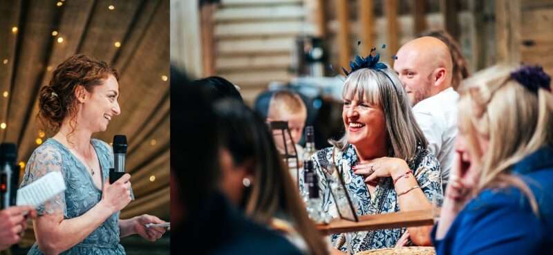 Guests laugh at speeches at Captains Wood Barn Essex documentary wedding photographer