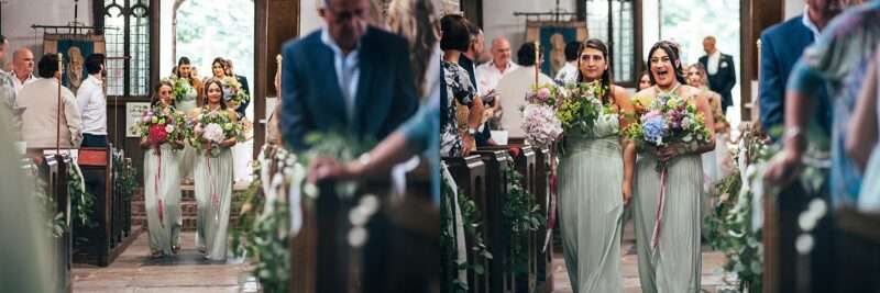 Bridesmaids walk down aisle in church