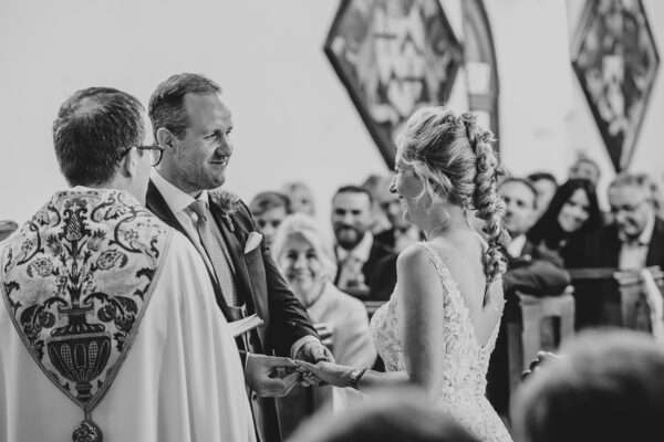 Bride and Groom exchange ring during church ceremony