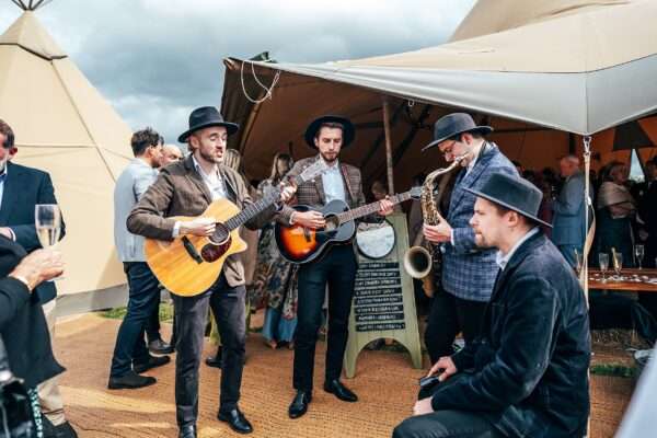 Band entertains guests for Essex back garden tipi wedding