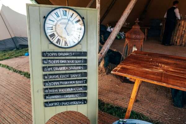 Vintage clock order of the day sign by Starry Eyed Events for Essex back garden tipi wedding