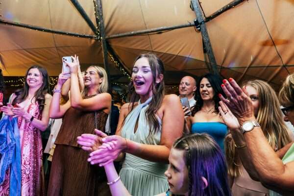 Guests on dance floor in tipi for Essex back garden wedding