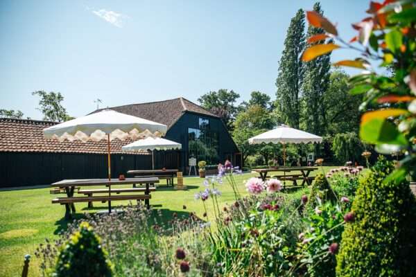 "Rustic barn summer wedding at Blake Hall in Essex with relaxed and happy bride and groom captured in a natural documentary style, perfect for anxious or nervous couples seeking authentic and beautiful wedding photography."