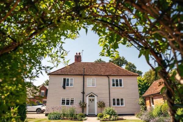 "Rustic barn summer wedding at Blake Hall in Essex with relaxed and happy bride and groom captured in a natural documentary style, perfect for anxious or nervous couples seeking authentic and beautiful wedding photography."