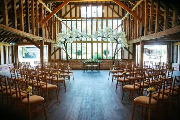 "Rustic barn summer wedding at Blake Hall in Essex with relaxed and happy bride and groom captured in a natural documentary style, perfect for anxious or nervous couples seeking authentic and beautiful wedding photography."