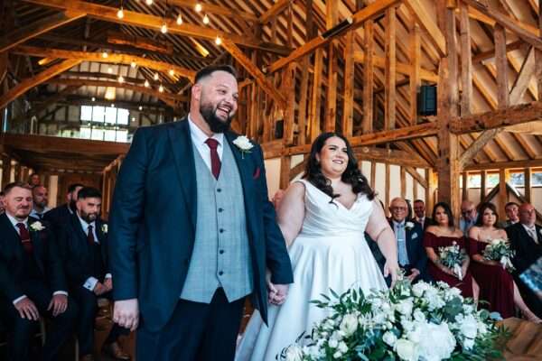 "Rustic barn summer wedding at Blake Hall in Essex with relaxed and happy bride and groom captured in a natural documentary style, perfect for anxious or nervous couples seeking authentic and beautiful wedding photography."