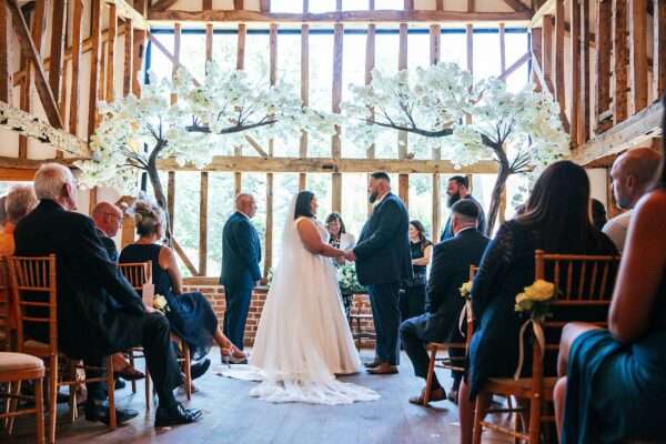 "Rustic barn summer wedding at Blake Hall in Essex with relaxed and happy bride and groom captured in a natural documentary style, perfect for anxious or nervous couples seeking authentic and beautiful wedding photography."