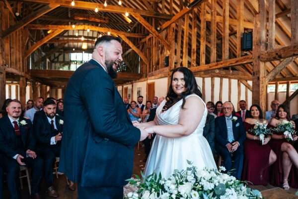 "Rustic barn summer wedding at Blake Hall in Essex with relaxed and happy bride and groom captured in a natural documentary style, perfect for anxious or nervous couples seeking authentic and beautiful wedding photography."