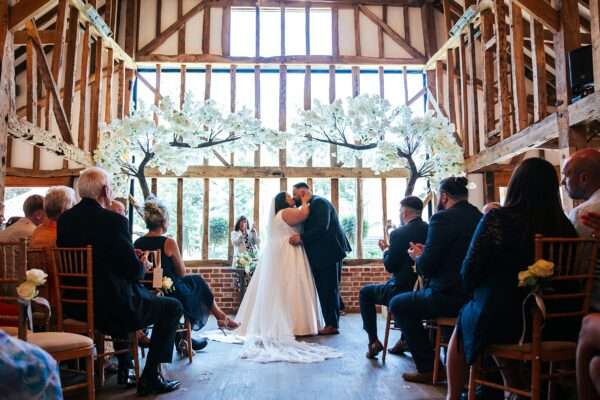 "Rustic barn summer wedding at Blake Hall in Essex with relaxed and happy bride and groom captured in a natural documentary style, perfect for anxious or nervous couples seeking authentic and beautiful wedding photography."