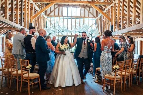 "Rustic barn summer wedding at Blake Hall in Essex with relaxed and happy bride and groom captured in a natural documentary style, perfect for anxious or nervous couples seeking authentic and beautiful wedding photography."