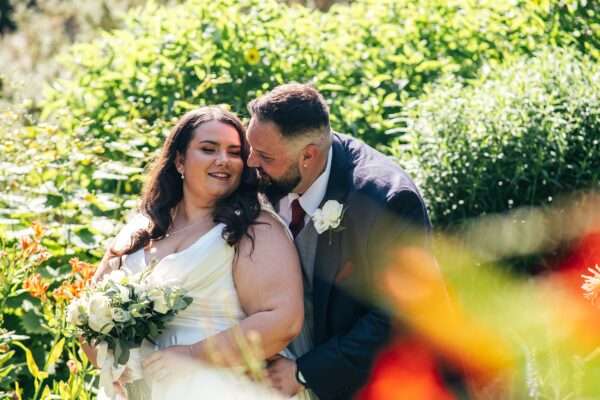 "Rustic barn summer wedding at Blake Hall in Essex with relaxed and happy bride and groom captured in a natural documentary style, perfect for anxious or nervous couples seeking authentic and beautiful wedding photography."