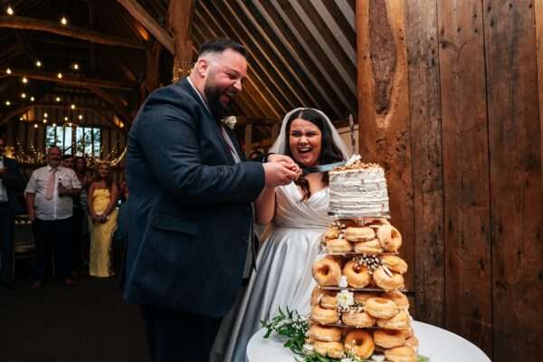 "Rustic barn summer wedding at Blake Hall in Essex with relaxed and happy bride and groom captured in a natural documentary style, perfect for anxious or nervous couples seeking authentic and beautiful wedding photography."