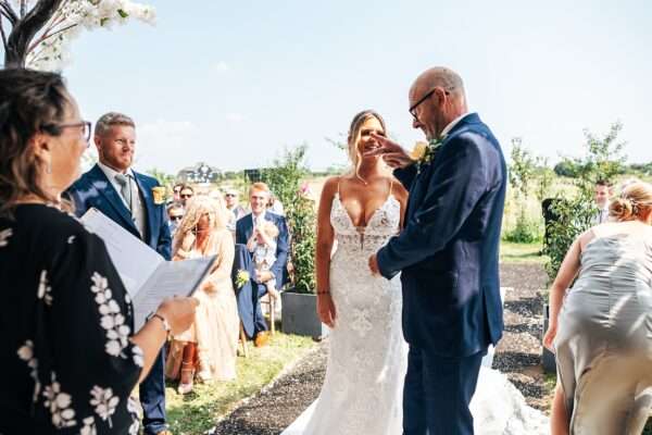 "Outdoor summer wedding at The Boundary in Essex with relaxed and happy bride and groom captured in a natural documentary style, perfect for anxious or nervous couples seeking authentic and beautiful wedding photography."