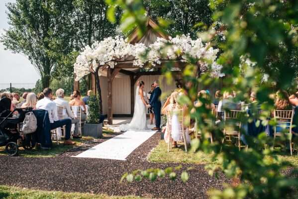 "Outdoor summer wedding at The Boundary in Essex with relaxed and happy bride and groom captured in a natural documentary style, perfect for anxious or nervous couples seeking authentic and beautiful wedding photography."