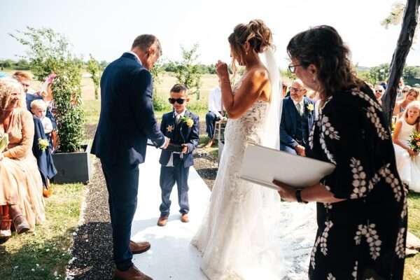 "Outdoor summer wedding at The Boundary in Essex with relaxed and happy bride and groom captured in a natural documentary style, perfect for anxious or nervous couples seeking authentic and beautiful wedding photography."