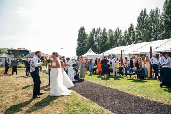 "Outdoor summer wedding at The Boundary in Essex with relaxed and happy bride and groom captured in a natural documentary style, perfect for anxious or nervous couples seeking authentic and beautiful wedding photography."