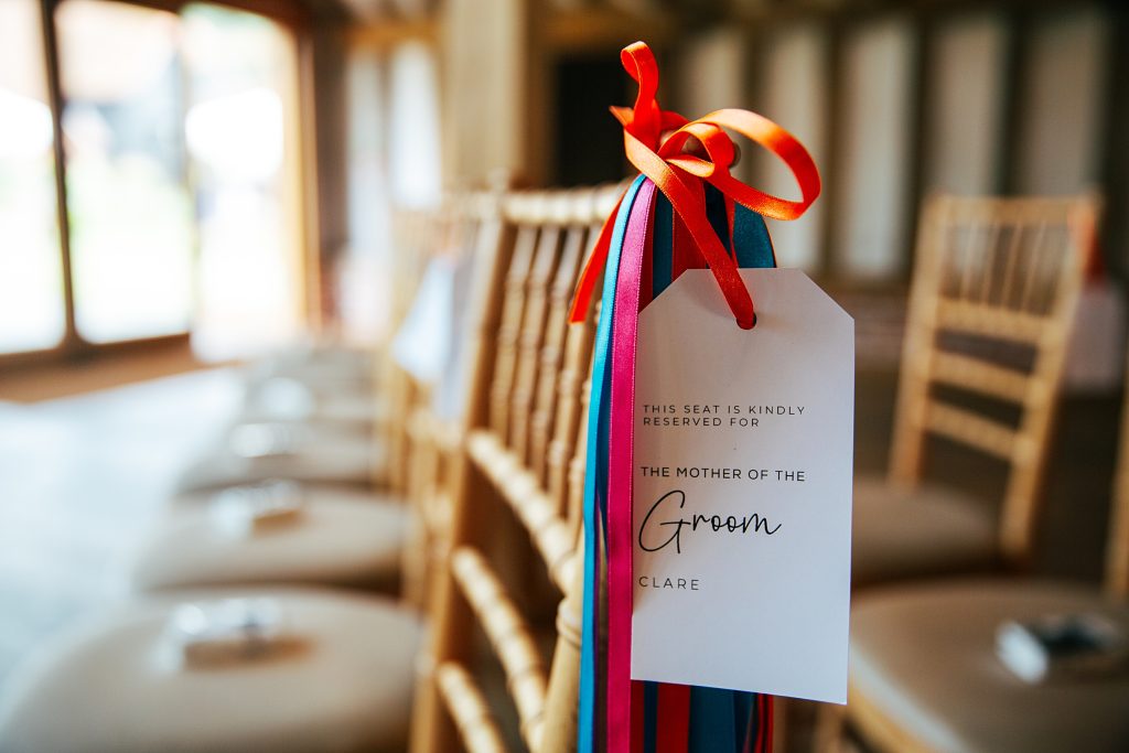 Colour ribbons on chair with guest tag