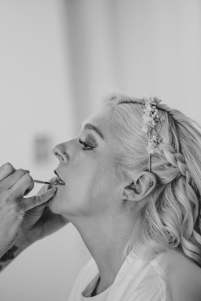bride has lipstick applied