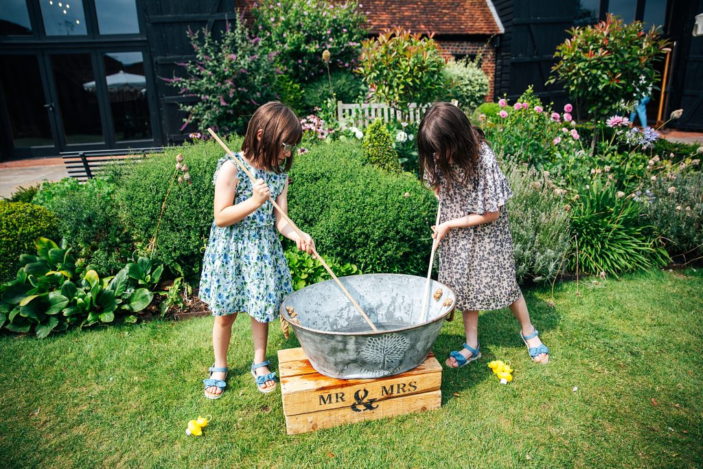 two little girls play hook a duck